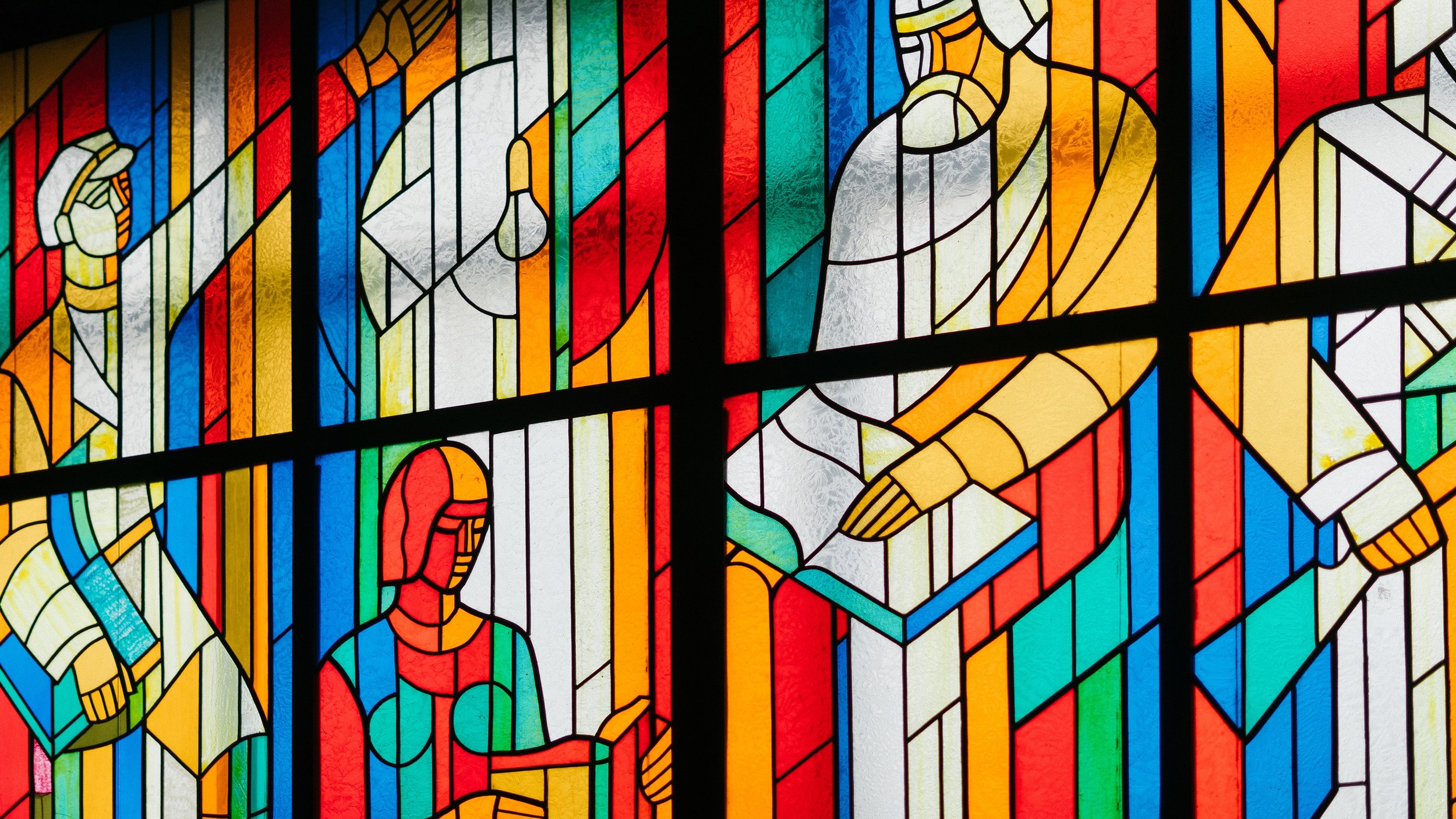 Blue-Red-Orange-Yellow Stain Glass Window of Persons Reading Opened Books