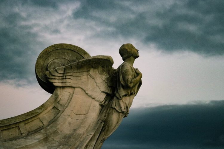 Sideshot of Statue of Angel with Arms Crossed on Chest