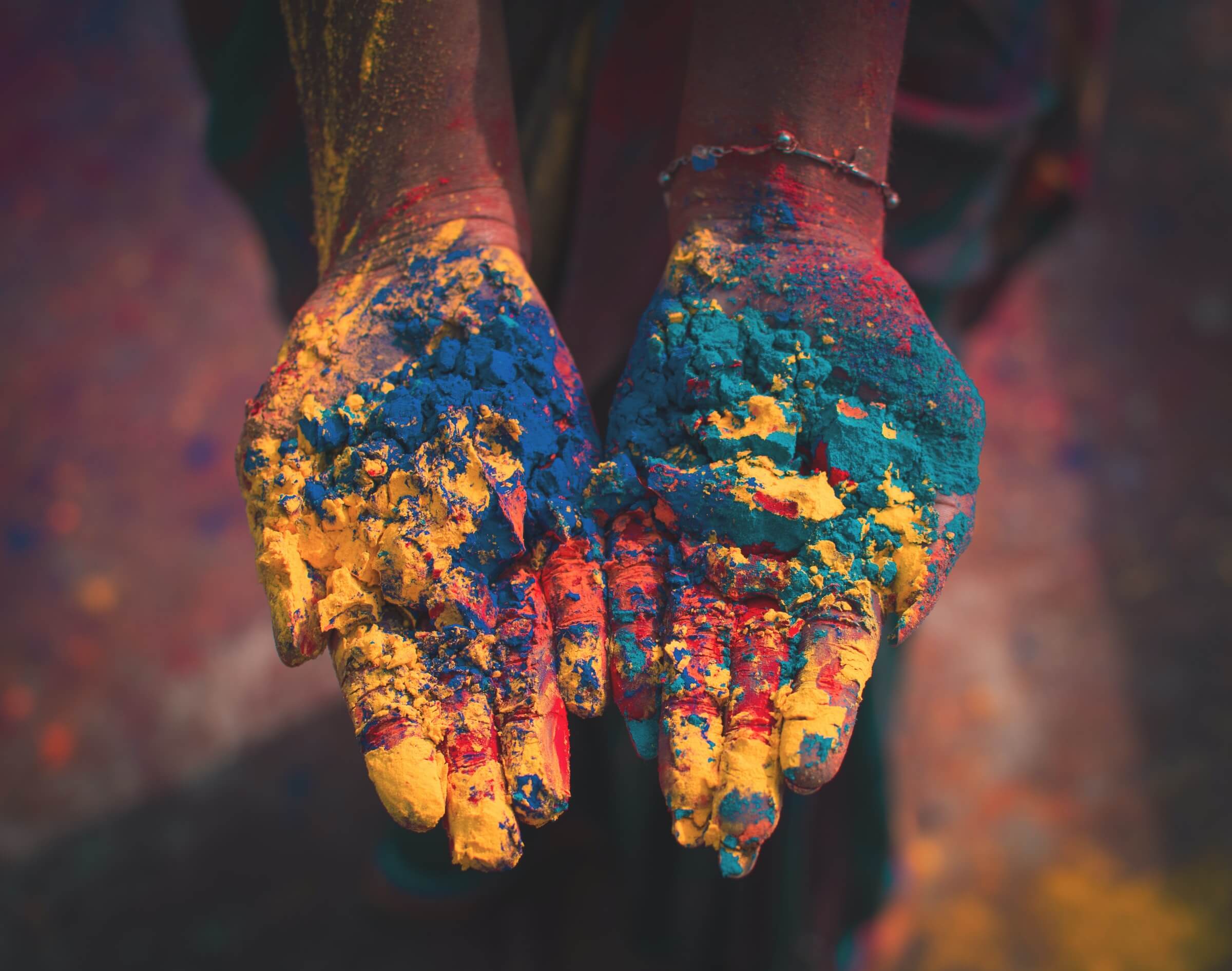 Two Hands, Palms Upward, Covered in Blue, Green, Red, Yellow Dye Powder